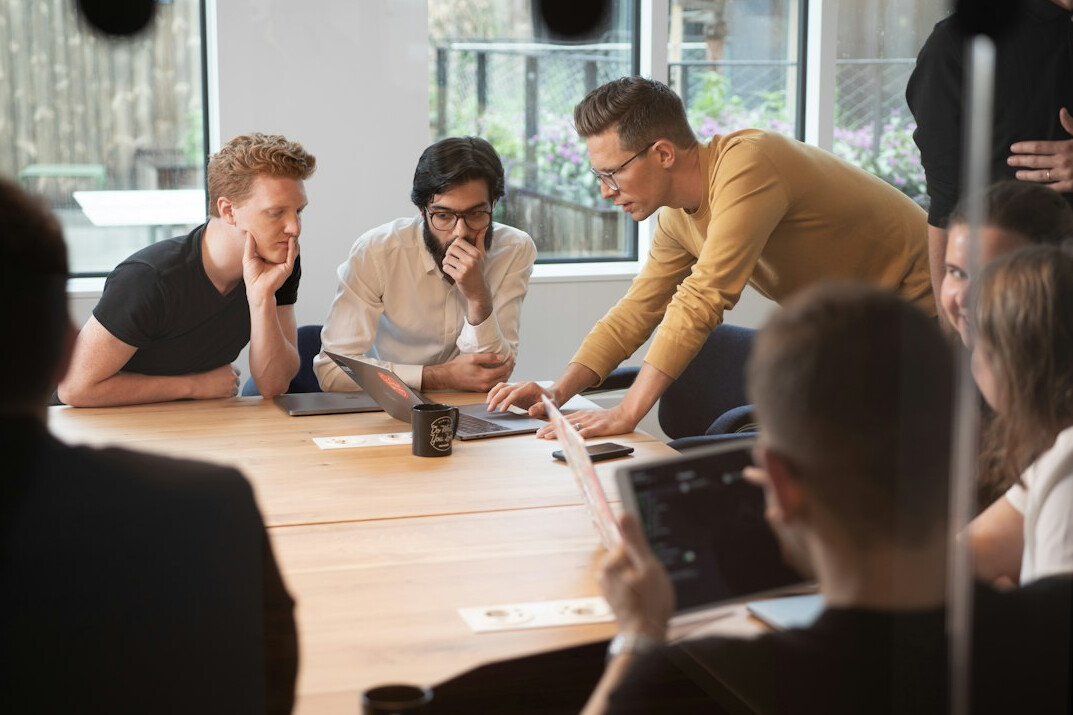 man leading team meeting